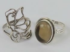 Two silver rings, one having open butter