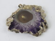 An amethyst geode slice mounted as a pen