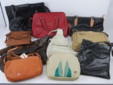 A black leather cross body bag by Taurus 22 x 27cm, together with a quantity of other handbags.