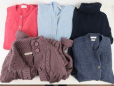 A quantity of 100% wool jumpers and long line cardigans size XS/S with labels for WoolOvers,