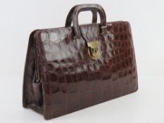 A vintage crocodile skin leather ladies brief case having suede lining,