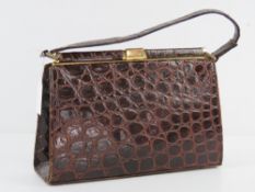 A vintage leather crocodile skin handbag bearing label for Fassbender England having leather lining,