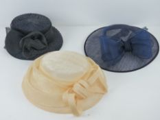Three ladies hats being blue, cream and navy/black.