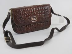 A vintage leather crocodile skin handbag having suede lining approx measurements 23.