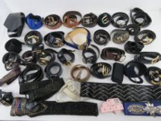 A large quantity of assorted vintage and contemporary ladies belts.
