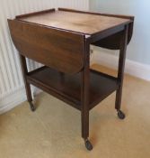 A c1950s drop leaf wheeled tea trolley w