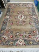 A Chinese woollen rug, gold ground with
