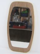 A c1960s wall mirror of geometric style