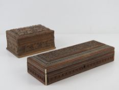 Two carved wooden boxes, 27 x 10cm and 1
