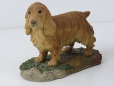 A figurine of a Golden Cocker Spaniel be