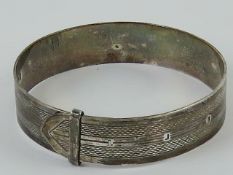 An HM silver bangle in the form of a bel