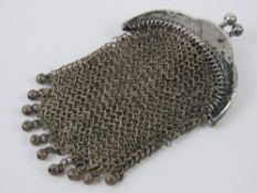 A white metal chain link purse having ch