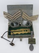 An RAF Officer's small kit box containing cutlery, brass button polishing board, goggles,