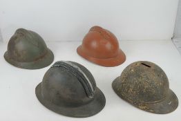 Four WWI/WWII French helmets.
