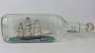 A large ship in gallon bottle model of the Cutty Sark and Gipsy Moth, 50cm in length.