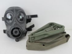 A folding Gulf War period entrenching tool in case,