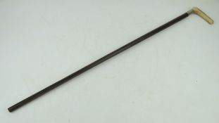 A British Military swagger stick having white metal collar bearing Suffolk Regiment emblem,