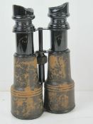 A pair of Army & Navy Paris binoculars, black painted and covered with black leather.