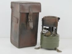 A post war military paraffin stove having broad arrow upon and dated 1954,