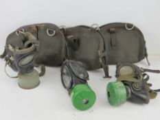 Three German Bundeswehr Draeger/CTG-RA gas masks with filters in carry cases.