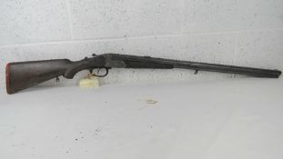 A deactivated German drilling double barrel combination hammer gun having engraved hunting scene to