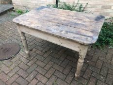 A 19thC pine plank top table having turned legs, drawer deficient, 112 x 74 x 76cm.
