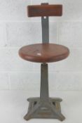 An elm top Singer (sewing machine) square shaped tapering stool with sprung back, seat 36cm dia,