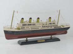 A model of the titanic on plinth base.