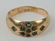 A 9ct gold Chester hallmarked Gypsy ring set with green stones in floral motif, size M-O, 1.6g.