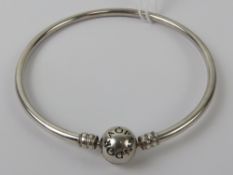 A silver Pandora charm bangle, stamped 925 ALE, 6cm internal dia, in presentation box.