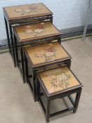 A nest of four 20th century high glass Oriental style tables, approx 51, 46,