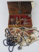 A Japanese carved wooden jewellery box containing a quantity of assorted costume jewellery