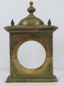 A heavy cast brass clock front of architectural form, 19cm wide, 28cm high, 1.75kg.