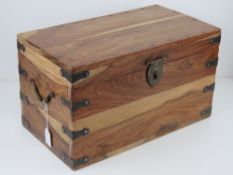 A contemporary wooden chest having iron stud work, end handles and latch, measuring 45 x 25.