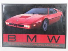 A 1980s BMW M1 'The Ultimate Driving Machine' poster, framed and glazed.