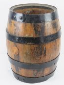 A coopered oak barrel standing 43cm high.