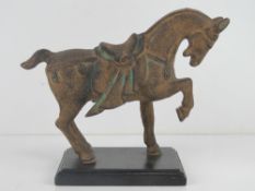 A cast iron figurine of an Eurasian horse with saddle upon, 28cm in length.
