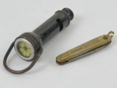A vintage whistle 'The Acme Guide' having compass to end. Together with a gilded pocket knife.