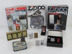 A quantity of Zippo and lighter collectables including; three Zippo manuals in Japanese,