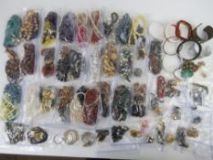 A quantity of assorted jewellery including glass beads necklaces, hard stone necklaces, bangles,