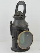 A railway lantern having spirit burner within with green and red glass slides,