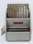 An International Cashier coin counting machine model W100 734 with dust cover and a quantity of pre