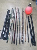 A large quantity of vintage fishing rods, nets etc. Including a fluorescent marker buoy.