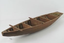 A vintage wooden model ship hull.