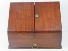 A mahogany stationary box opening to reveal pigeon holes within,