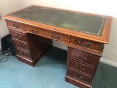 A contemporary Victorian style kneehole desk, leather writing surface,