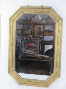 A large octagonal wall mirror having carved and gold painted wooden frame measuring 79 x 53.5cm.