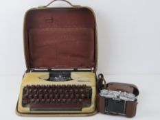 A vintage Olympia typewriter in case.