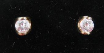A pair of white stone earrings having 9ct gold butterfly backs, no apparent hallmark to earrings.