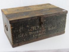 A vintage pine trunk with end handles and painted to the front 'RM..